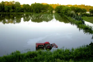 Submerged tractor in flooded field