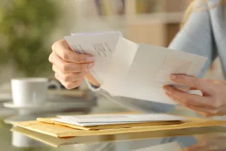 Woman opening letter at business address